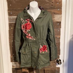 Army green, cinched waist jacket, with crocheted flower patches.